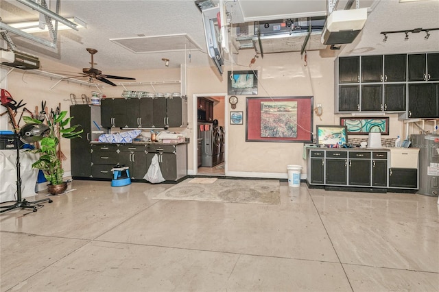 kitchen featuring ceiling fan, water heater, a textured ceiling, and concrete floors