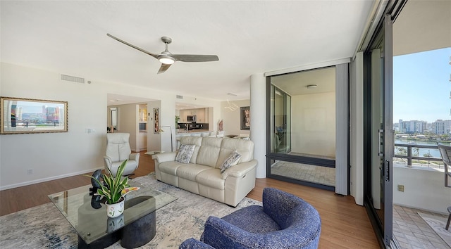 living room featuring light hardwood / wood-style floors and ceiling fan