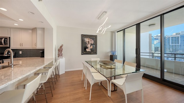 dining space with light hardwood / wood-style floors