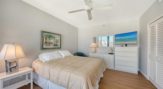 bedroom featuring ceiling fan, wood-type flooring, and a closet