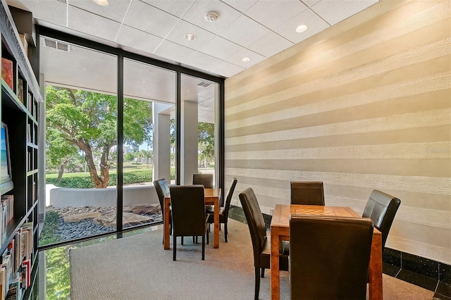 carpeted dining area featuring plenty of natural light