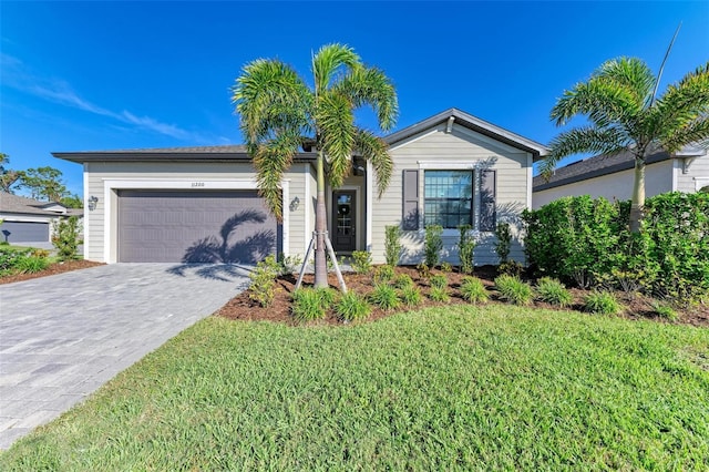 view of front of property with a garage and a front lawn