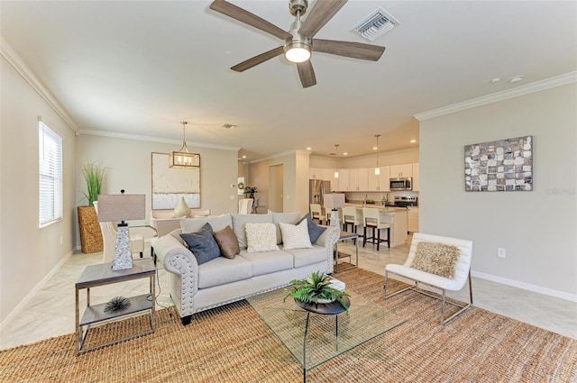 living room with crown molding and ceiling fan with notable chandelier