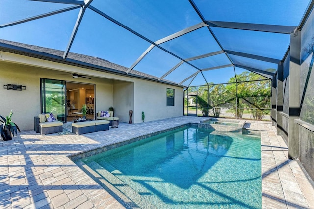 view of swimming pool featuring glass enclosure, ceiling fan, and a patio area