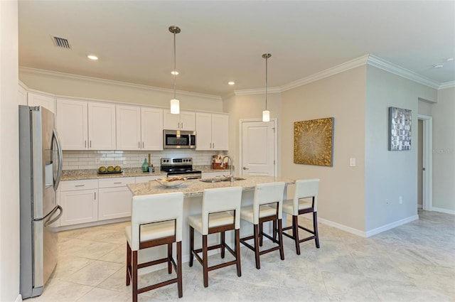 kitchen with white cabinetry, sink, stainless steel appliances, and a center island with sink