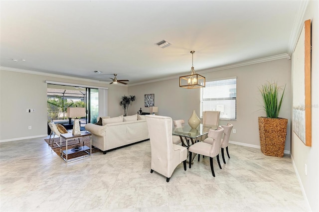 dining room with crown molding and ceiling fan with notable chandelier