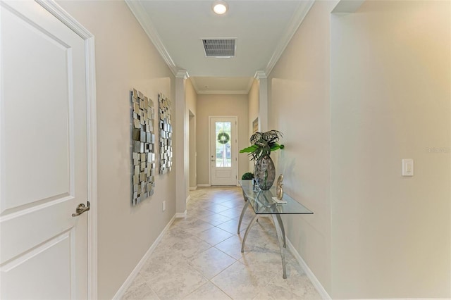 interior space with ornamental molding and light tile patterned floors