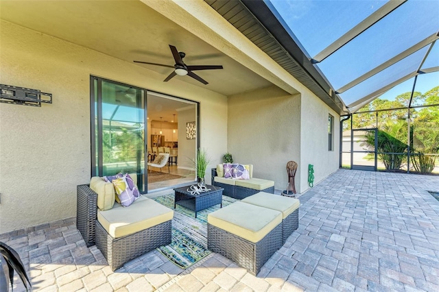 view of patio / terrace with outdoor lounge area, glass enclosure, and ceiling fan