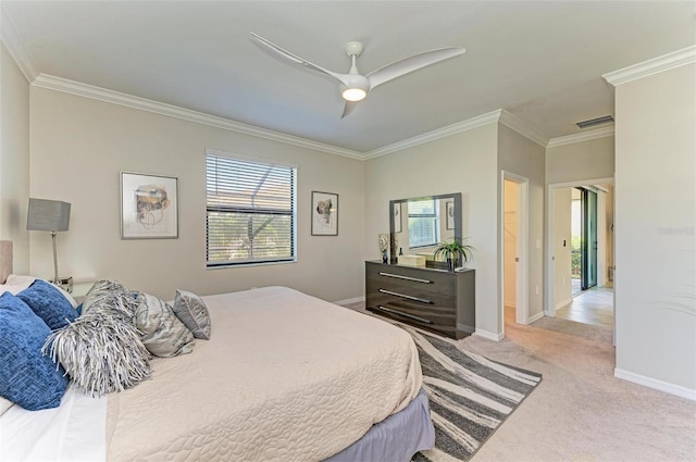 carpeted bedroom featuring ceiling fan and crown molding