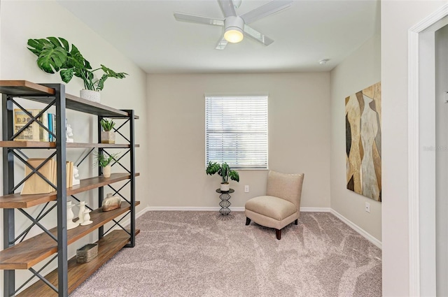 sitting room with ceiling fan and carpet floors