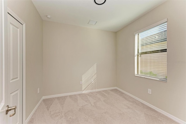 spare room featuring light colored carpet