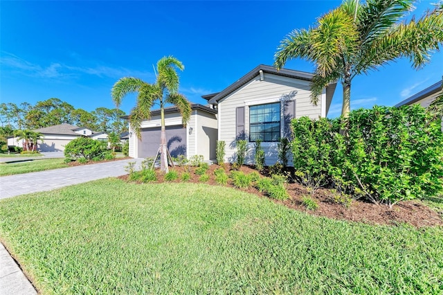 view of front facade with a front yard and a garage