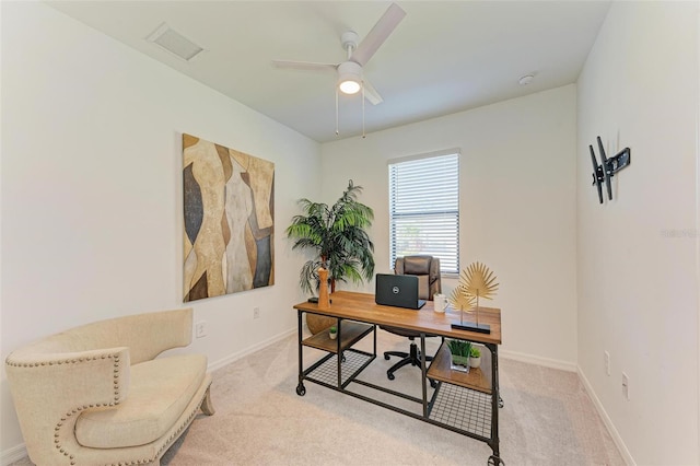 carpeted office space featuring ceiling fan