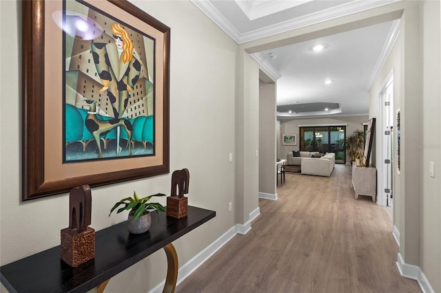 corridor with hardwood / wood-style floors and ornamental molding