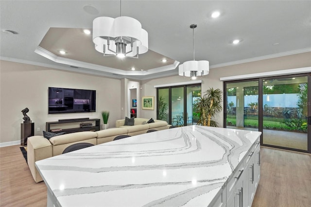 interior space featuring a chandelier, white cabinetry, a healthy amount of sunlight, and hanging light fixtures