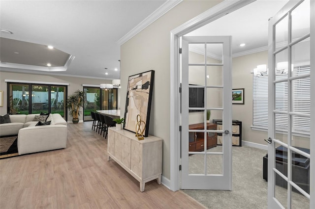 living room with light wood-type flooring, crown molding, and french doors