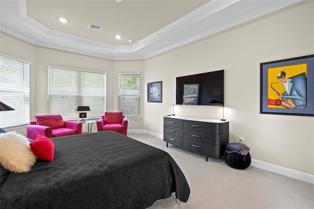 carpeted bedroom with a raised ceiling, multiple windows, and ornamental molding