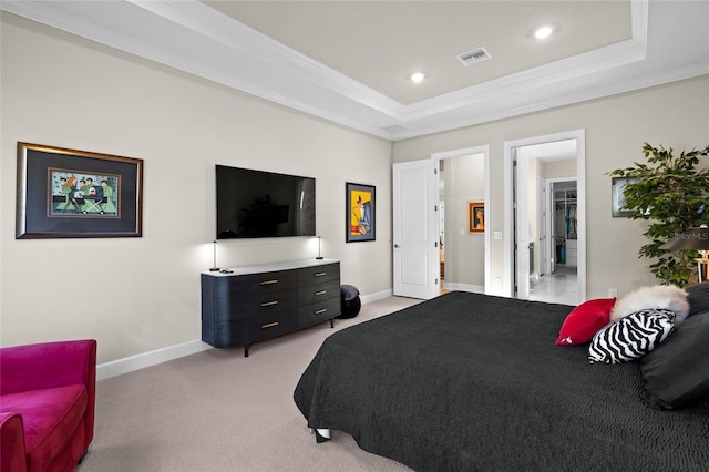 bedroom featuring light carpet, a tray ceiling, and ornamental molding