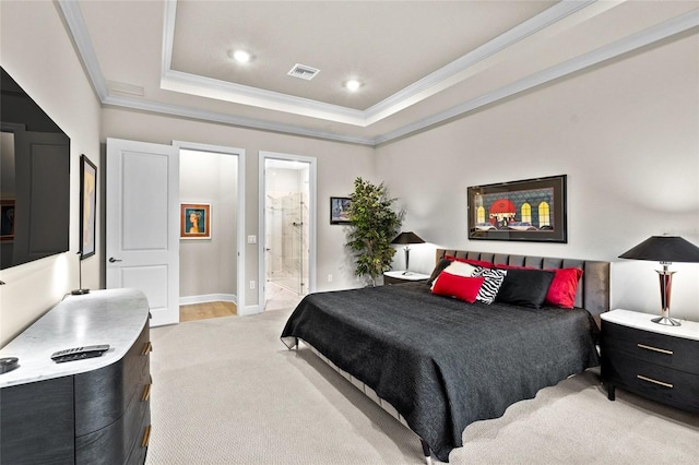 carpeted bedroom with ensuite bathroom, a raised ceiling, and crown molding