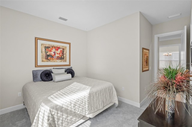 bedroom featuring carpet floors and an inviting chandelier