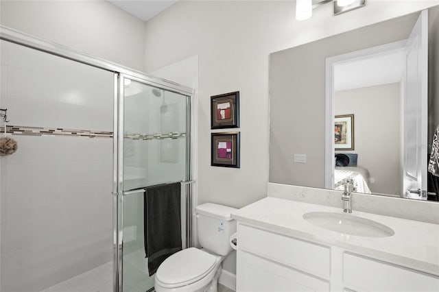 bathroom featuring vanity, toilet, and a shower with door