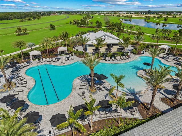 view of swimming pool featuring a patio area and a water view