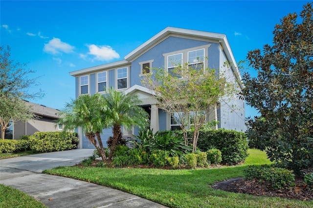 view of front of property with a front lawn and a garage