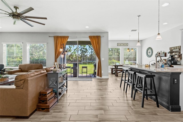 living room featuring ceiling fan and light wood-type flooring