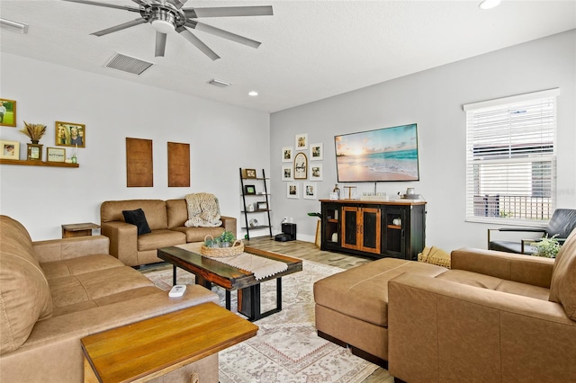 living room featuring light hardwood / wood-style floors and ceiling fan