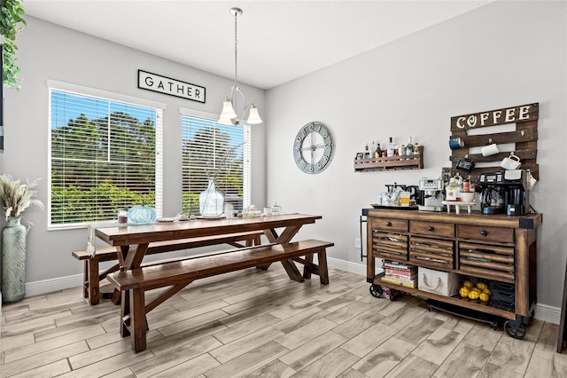 dining space featuring light hardwood / wood-style floors and a chandelier