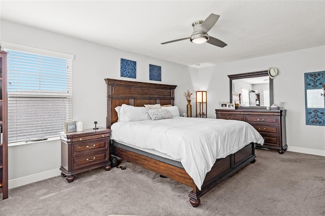 bedroom with ceiling fan and light carpet