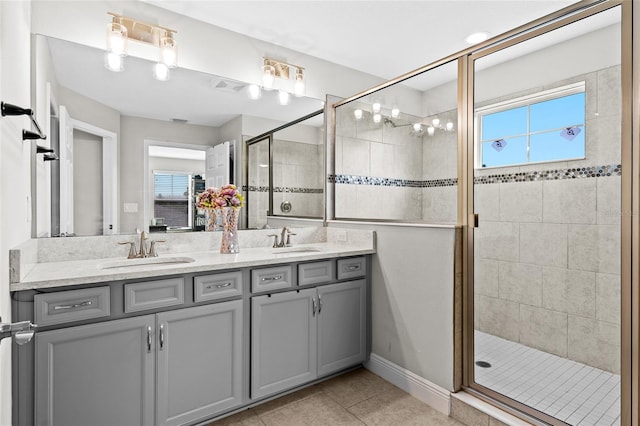 bathroom featuring tile patterned flooring, vanity, and walk in shower