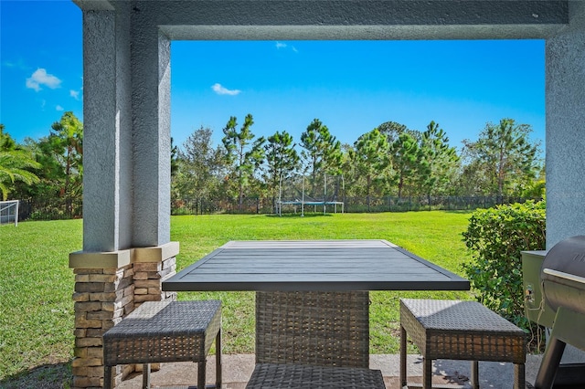 view of patio featuring a trampoline and grilling area