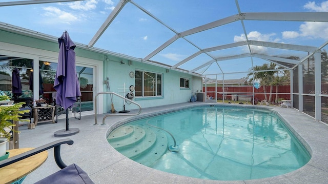 view of pool with a patio area and a lanai