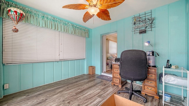 home office with ceiling fan and hardwood / wood-style floors