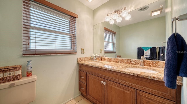 bathroom with tile patterned floors, vanity, and toilet