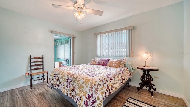 bedroom with hardwood / wood-style flooring and ceiling fan