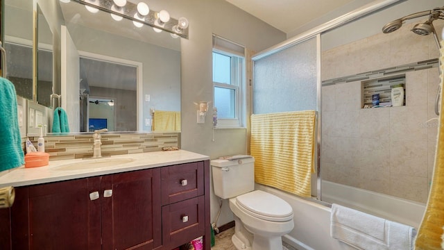 full bathroom with vanity, ceiling fan, tiled shower / bath combo, toilet, and tasteful backsplash