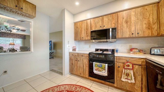 kitchen with light tile patterned floors and black appliances