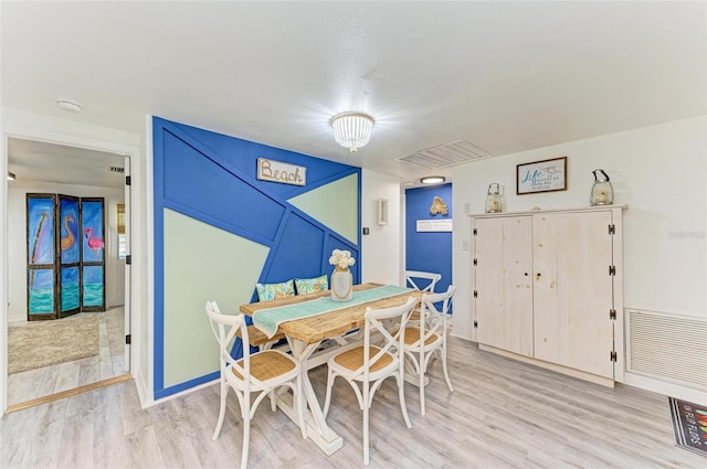 dining space featuring light hardwood / wood-style flooring