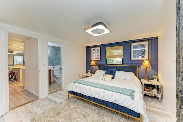 bedroom featuring hardwood / wood-style floors and ensuite bathroom