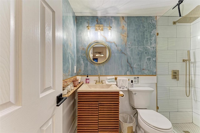 bathroom featuring vanity, toilet, and tiled shower