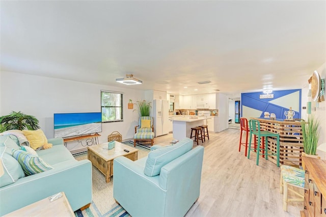 living room with light hardwood / wood-style floors