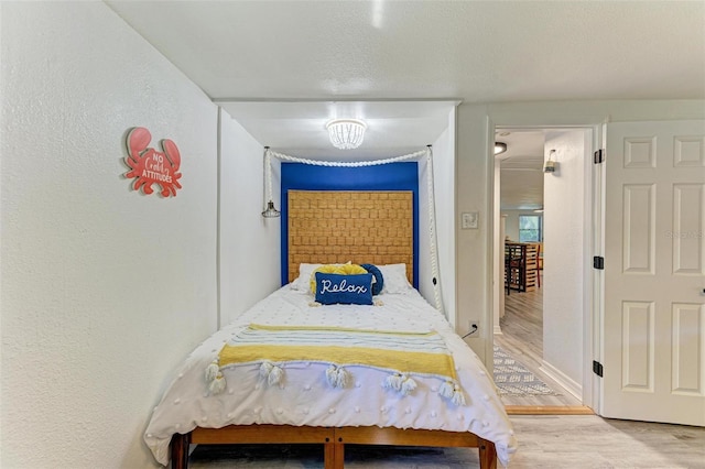 bedroom with wood-type flooring