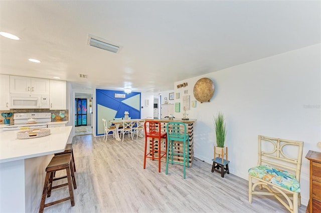 dining space featuring light wood-type flooring