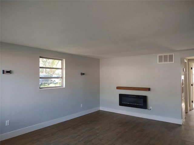 unfurnished living room with dark hardwood / wood-style floors