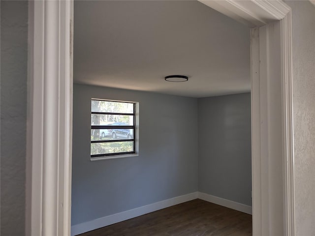 spare room with dark hardwood / wood-style floors