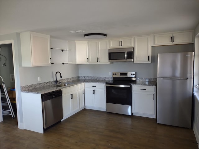 kitchen featuring sink, white cabinets, stainless steel appliances, and dark hardwood / wood-style floors