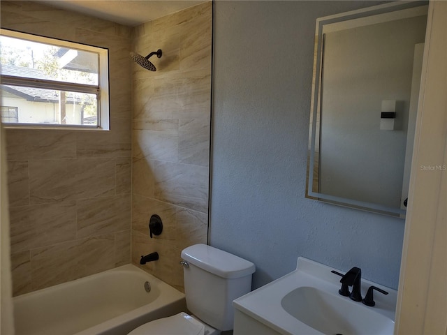 full bathroom featuring toilet, vanity, and tiled shower / bath