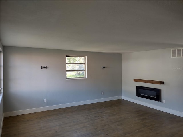 unfurnished living room featuring dark hardwood / wood-style floors